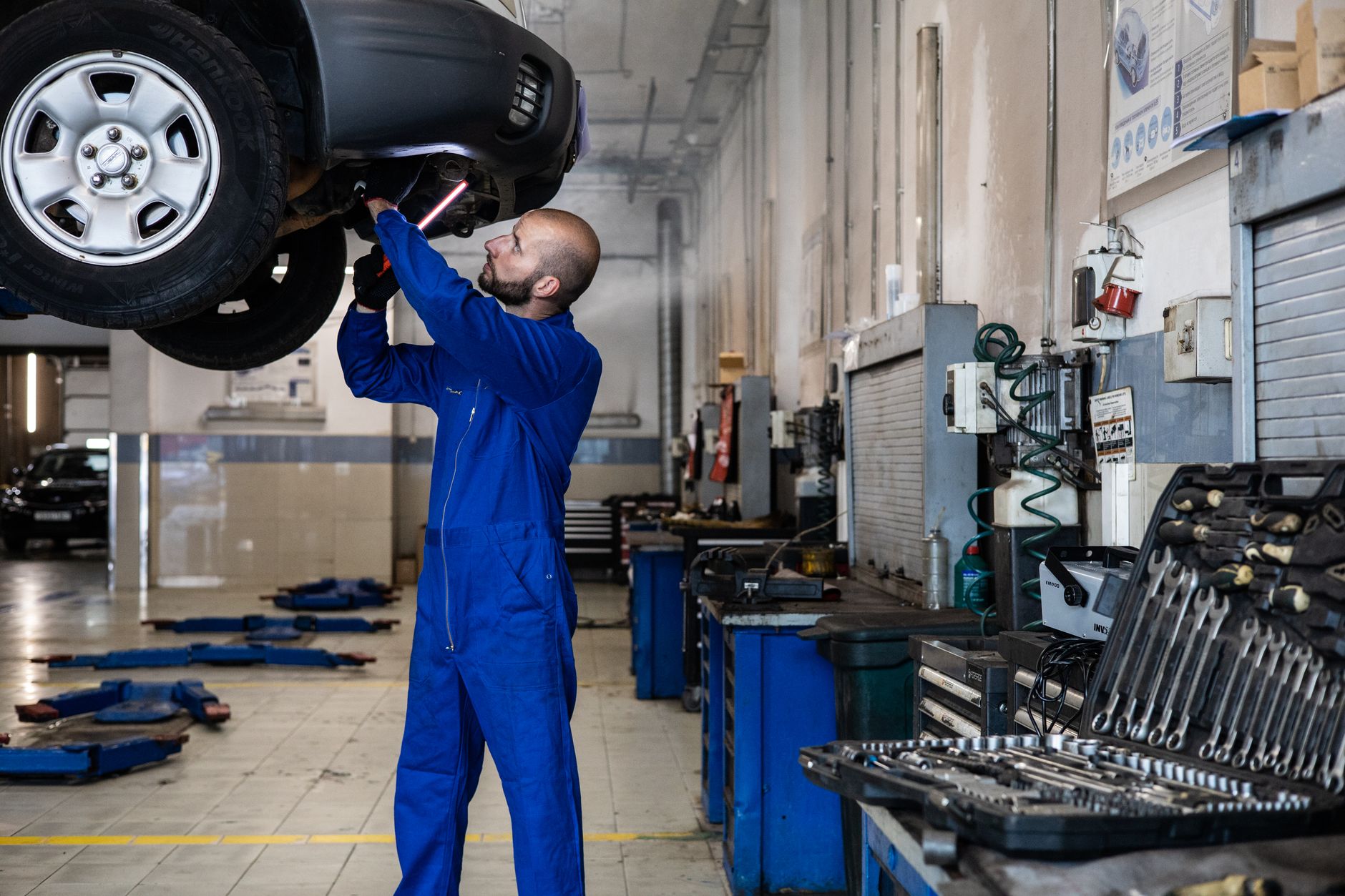 Technician inspecting a recovered vehicle